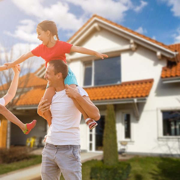 Happy family near new house. Real estate concept